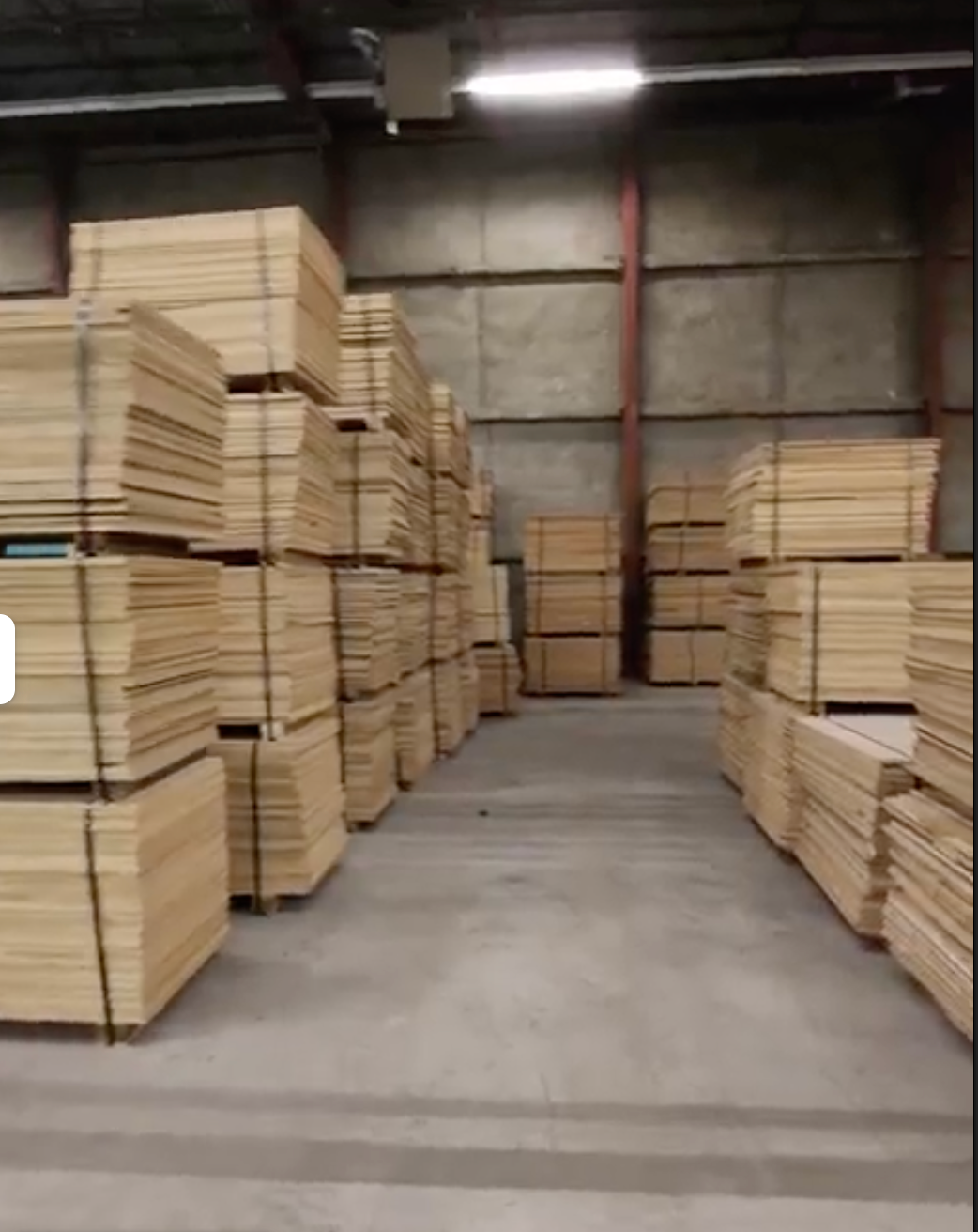 Warehouse filled with stacked premium lumber and plywood sheets